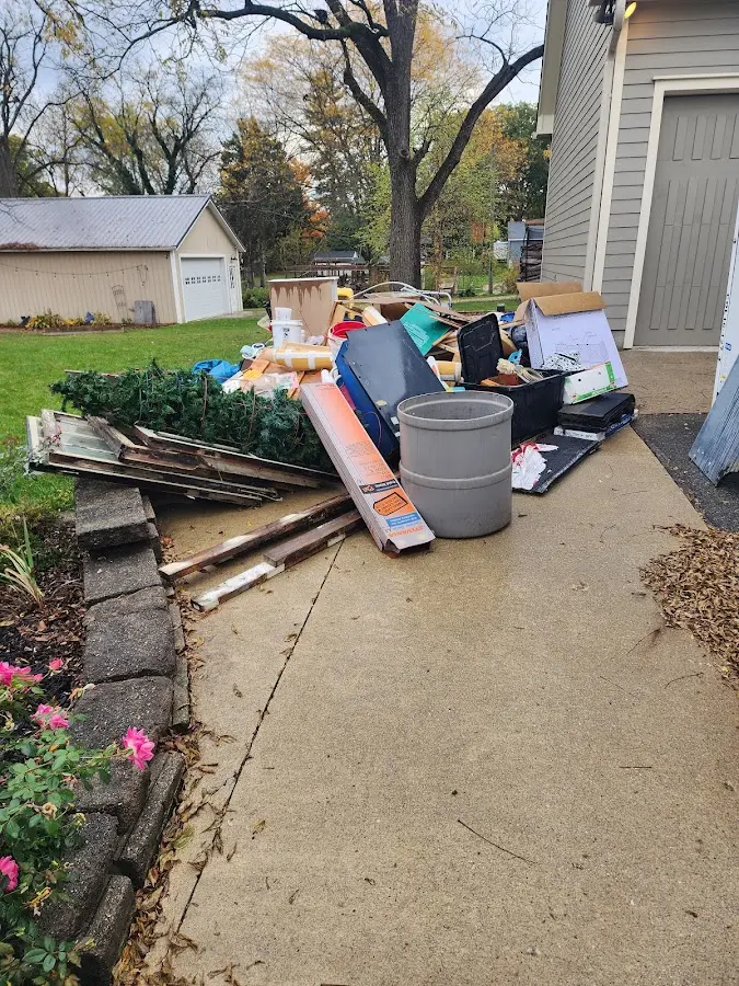Dumpster being loaded with debris for 12 Yard Dumpster Rental in Bay Village